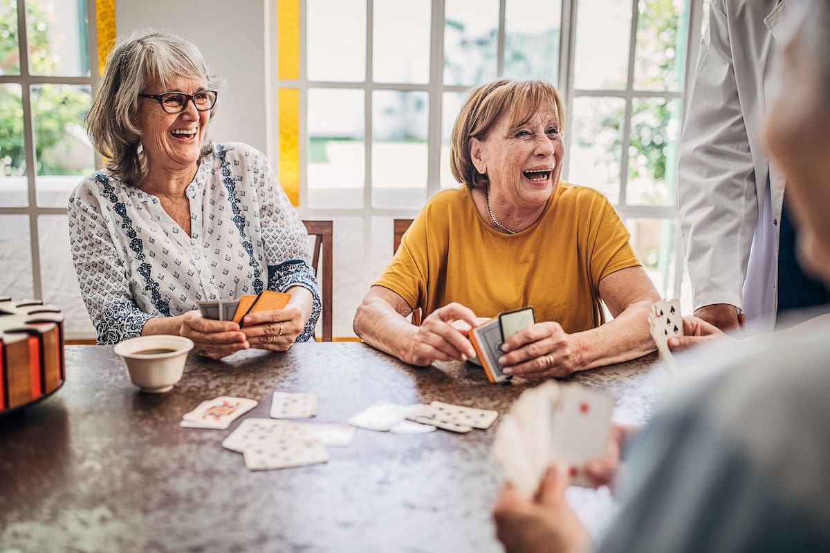 Group of people, senor people playing cards at Springwood Court.